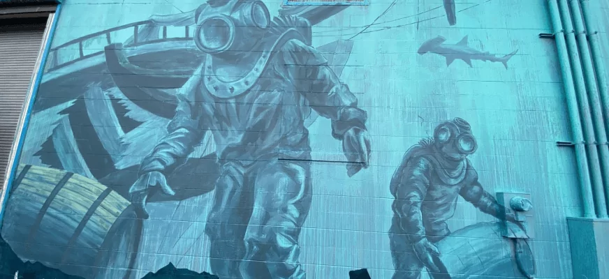 A mural of a man in a diving suit on a building.