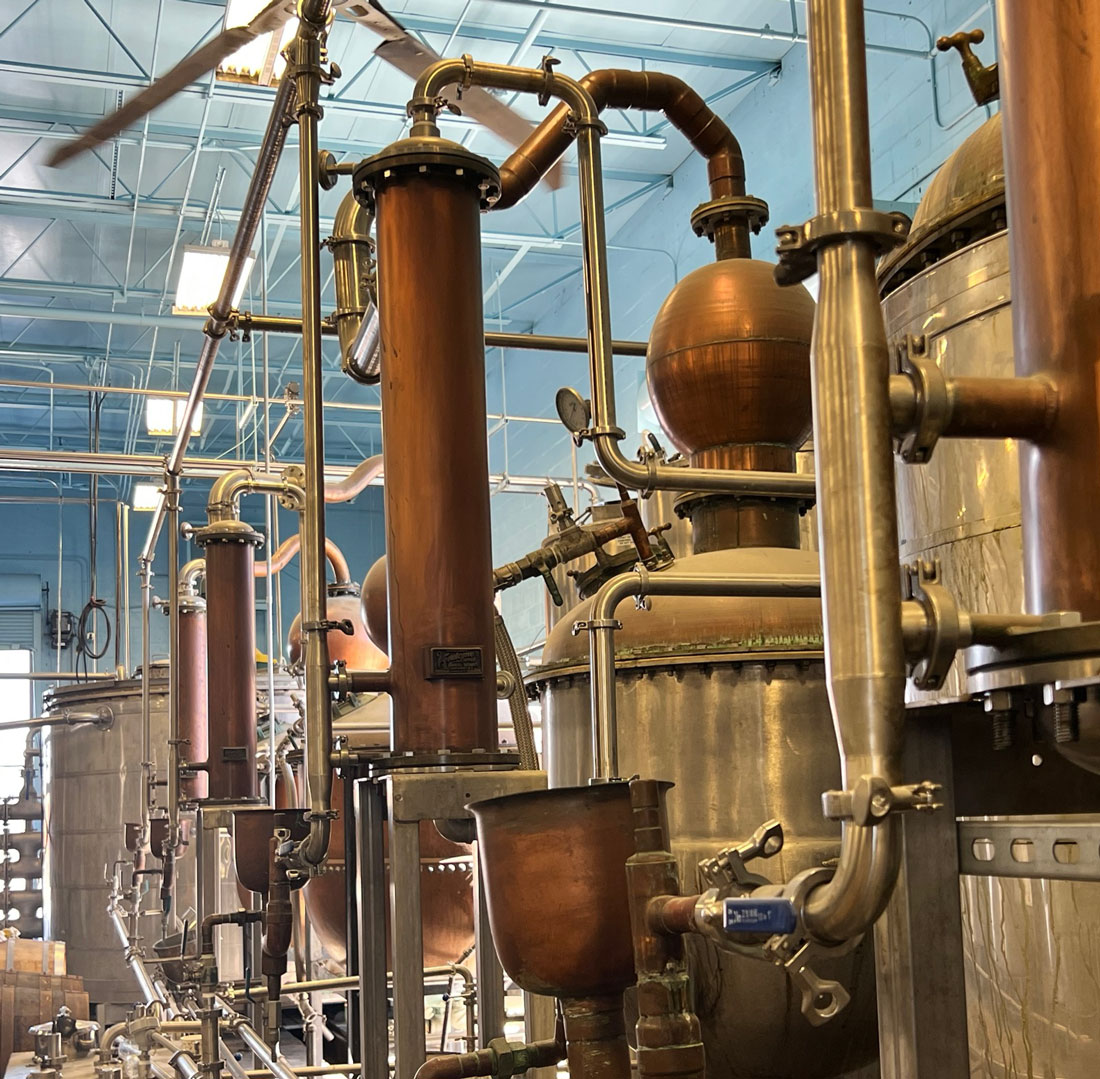 A group of copper vats sitting next to each other.