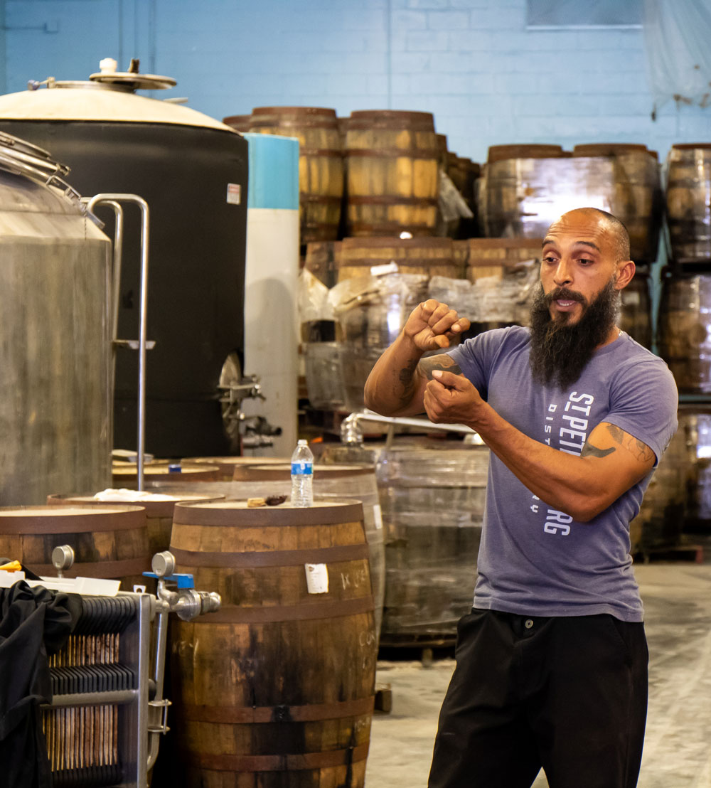 A person pouring a drink into a glass.